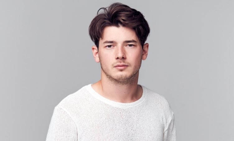 Studio Portrait Of Young Man With Serious 8YSPPQM 1